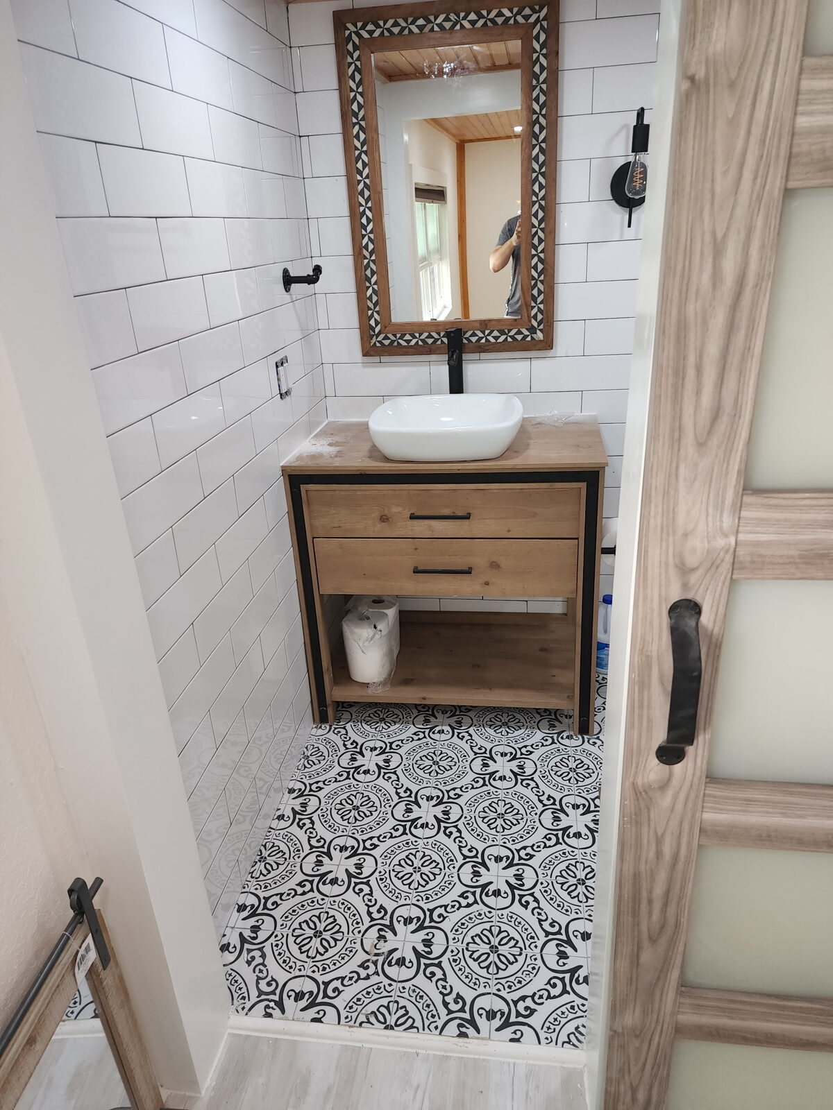 Finished bathroom with patterned tile floor