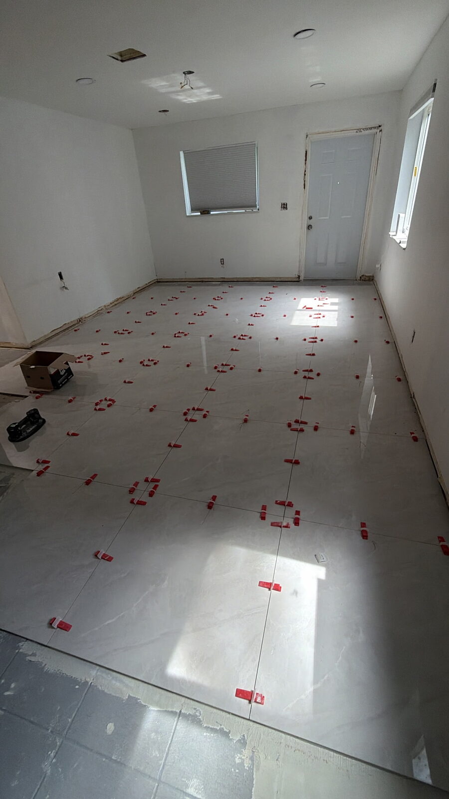 Tile floor being laid with spacers